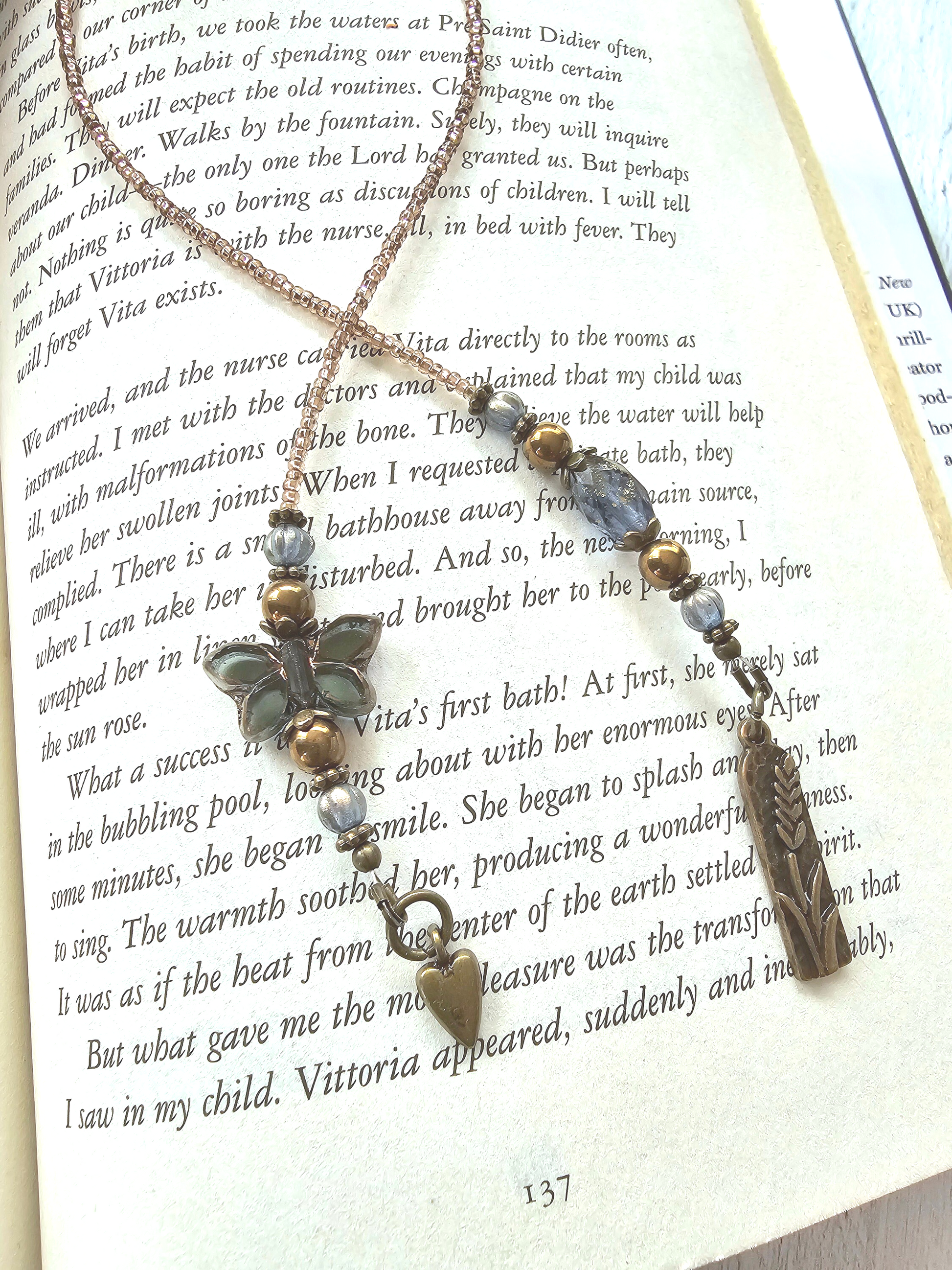 a book with a necklace on top of it