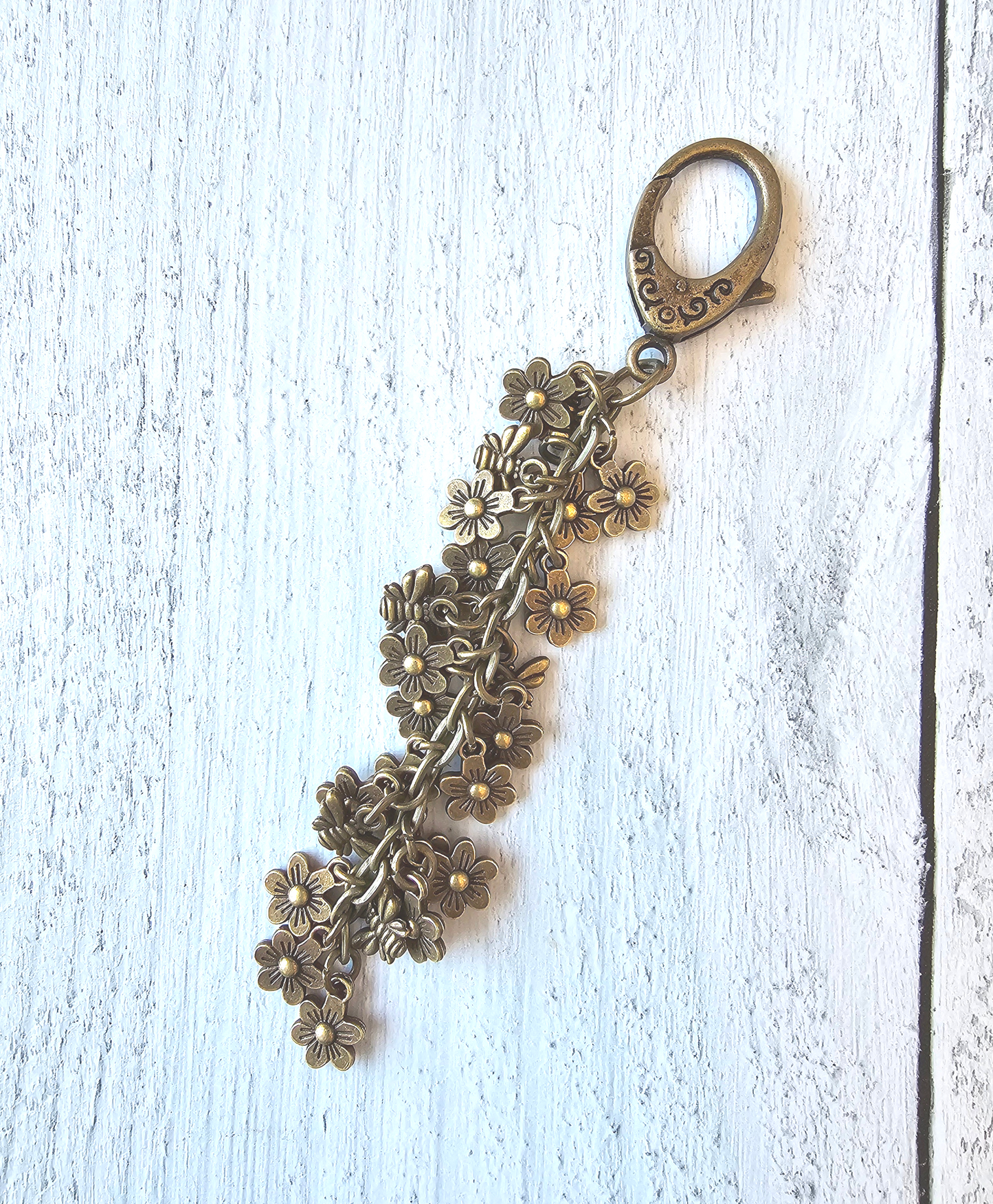 a key chain with a bunch of flowers on it